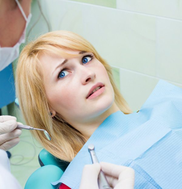 Woman afraid in the dental chair
