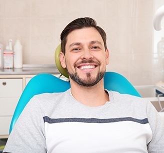 Man sitting in treatment chair smiling
