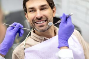 Man smiling after his root canal retreatment